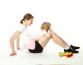 Young woman and her daughter doing sport exercises