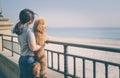 Young woman with her dog on the beach . Royalty Free Stock Photo