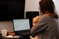 Young woman with her dog using computer in her living room Royalty Free Stock Photo