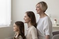 Young woman, her elderly mother and daughter posing indoors Royalty Free Stock Photo