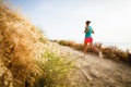 Young woman on her evening jog along the seacoast Royalty Free Stock Photo