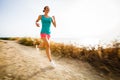 Young woman on her evening jog along the seacoast