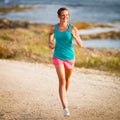 Young woman on her evening jog along the seacoast Royalty Free Stock Photo