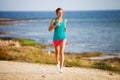 Young woman on her evening jog along the seacoast Royalty Free Stock Photo