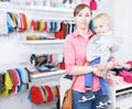 Young woman with her kid who are shopping in child store Royalty Free Stock Photo