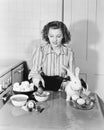 Young woman in her kitchen coloring Easter eggs