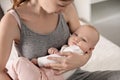 Young woman with her little baby resting after breast feeding on bed Royalty Free Stock Photo