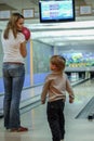 Young woman and her little son playing bowling. Active lifestyle of modern russian family.
