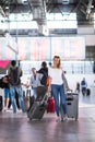 Young woman with her luggage at an international airport