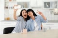 Young woman and her mature mother taking selfie at table Royalty Free Stock Photo