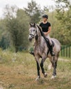 Young woman and her red horse during a calm trail ride