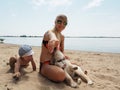 The young woman with her son and puppy on the beach Royalty Free Stock Photo