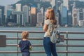 Young woman and her son taking photos of victoria harbor in Hong Kong, China Royalty Free Stock Photo