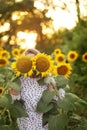 young woman hides her face behind a sunflower Royalty Free Stock Photo