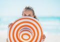 Young woman hiding behind hat on beach Royalty Free Stock Photo