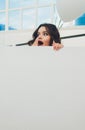 Young woman hiding in a carton box. Royalty Free Stock Photo