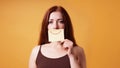 young woman hiding emotion with fake smile drawn on paper