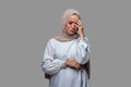 Young woman in hijab posing with headache, dizzy and sad expression Royalty Free Stock Photo