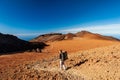 Young woman hiker with backpack trekking near Pico del Teide mountain in El Teide National park. Tenerife, Canary Islands, Spain Royalty Free Stock Photo