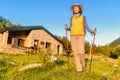 Woman hiker camping near the beautiful shelter stone hut building in Pyrenees mountains. Hiking and adventure concept Royalty Free Stock Photo