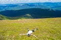 Young woman hiker lies on the top of hill and Enjoy beautiful mountain valley view Royalty Free Stock Photo