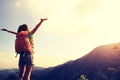 Young woman hiker open arms at mountain peak Royalty Free Stock Photo