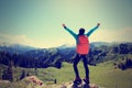 Young woman hiker open arms on mountain top Royalty Free Stock Photo