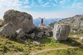 young woman hiker with outstretched arms, standing between big rocks at Rofan alps Royalty Free Stock Photo