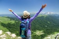 Woman hiker on a rock with backpack and looking to the horizon admiring view Royalty Free Stock Photo