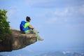 woman hiker sit on mountain top cliff enjoy the view Royalty Free Stock Photo