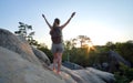 Young woman hiker standing alone with outstretched arms on mountain footpath enjoying view of morning nature on Royalty Free Stock Photo