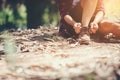 Young woman hiker stops to tie her shoe on a summer hiking trail Royalty Free Stock Photo