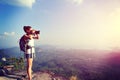 Young woman hiker taking photo with dslr camera Royalty Free Stock Photo