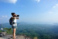 Young woman hiker taking photo with dslr camera Royalty Free Stock Photo