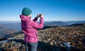 Young woman hiker taking picture with her smartphone Royalty Free Stock Photo