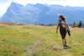 Young woman hiker walks in the high mountain trail in the Italian Alps on the Dolomites mountain range Royalty Free Stock Photo