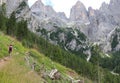 Young woman hiker walks on trail on European alps in Italy Royalty Free Stock Photo