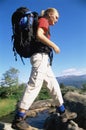 Young woman hiking across a river Royalty Free Stock Photo