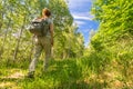 Young woman hiking through the beautiful green forest in summer Royalty Free Stock Photo