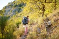 Young woman hiking in countryside. Concepts of adventure, extreme survival, orienteering. Backpacking hike Royalty Free Stock Photo