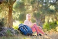 Young woman hiking in countryside. Girl resting under olive tree. Concepts of adventure, extreme survival, orienteering. Royalty Free Stock Photo