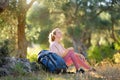 Young woman hiking in countryside. Girl resting under the tree. Concepts of adventure, extreme survival, orienteering. Single Royalty Free Stock Photo