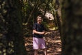 young woman hiking on a forest track. enjoying her holiday. woman walking in nature.