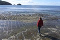 Young woman hiking over the Tessellated Pavement in Tasman Peninsula Tasmania Australia Royalty Free Stock Photo