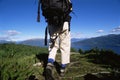 Young woman hiking towards a lake Royalty Free Stock Photo