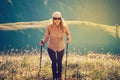 Young Woman hiking with trekking poles Travel Lifestyle concept Royalty Free Stock Photo