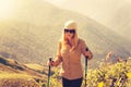 Young Woman hiking with trekking poles Travel Lifestyle concept Royalty Free Stock Photo