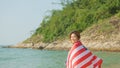 young women hold American flags on the beach and the sea on their summer vacation and they smile and enjoy their vacation Royalty Free Stock Photo