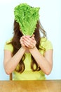 Young woman hold beam lettuche in front of his face. Royalty Free Stock Photo