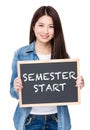 Young woman hold with chalkboard showing phrase of semester star